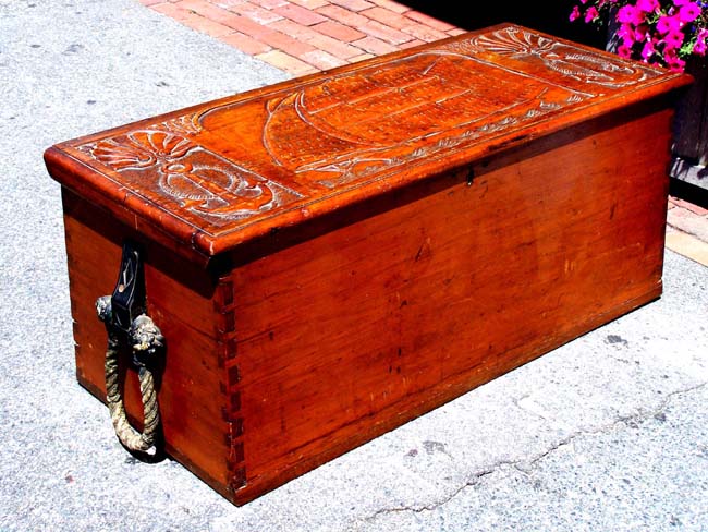 A 19th century American made Sailor's Chest with Rarely seen carved lid featuring a ship flanked by two anchors circa 1850.